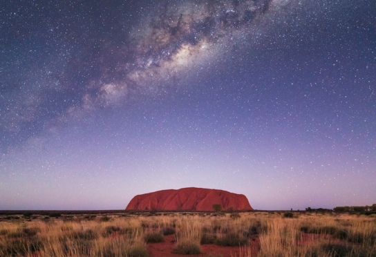 Uluru rock in Australia under milky way